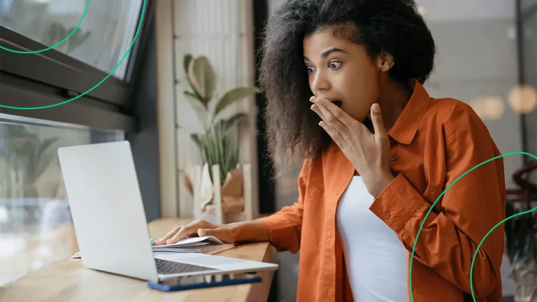 Empreendedora com expressão de muita surpresa ao ver a Liquidação Fantástica do Magazine Luiza no seu notebook