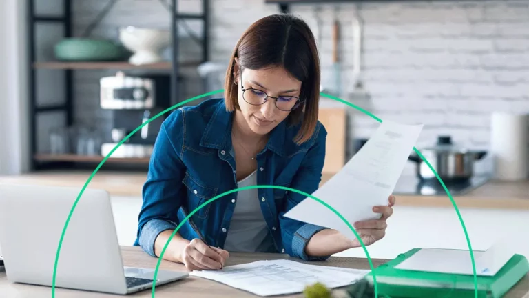 Empreendedora conferindo documentos, estudando a situação do seu negócio e refletindo sobre integrações no e-commerce