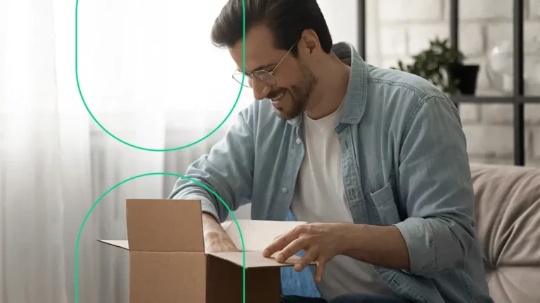 Homem abrindo uma encomenda adquirida no e-commerce