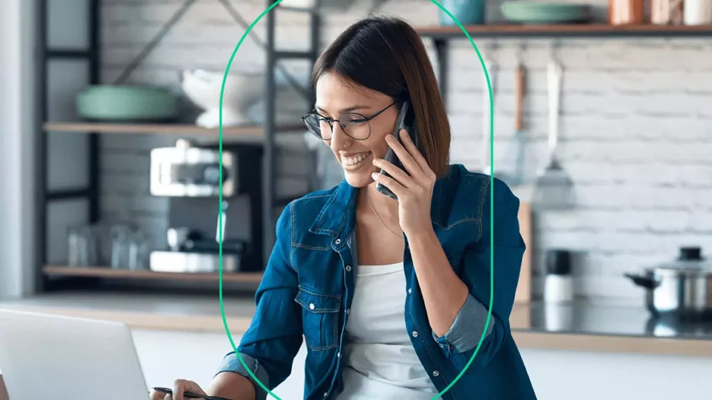 Empreendedora MEI sorrindo no telefone ao conversar com a contabilidade